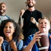 People cheering while watching the Super Bowl